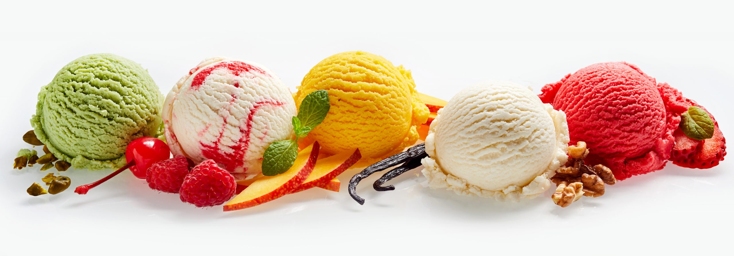 Scoops of ice cream with fruit, nuts and vanilla
